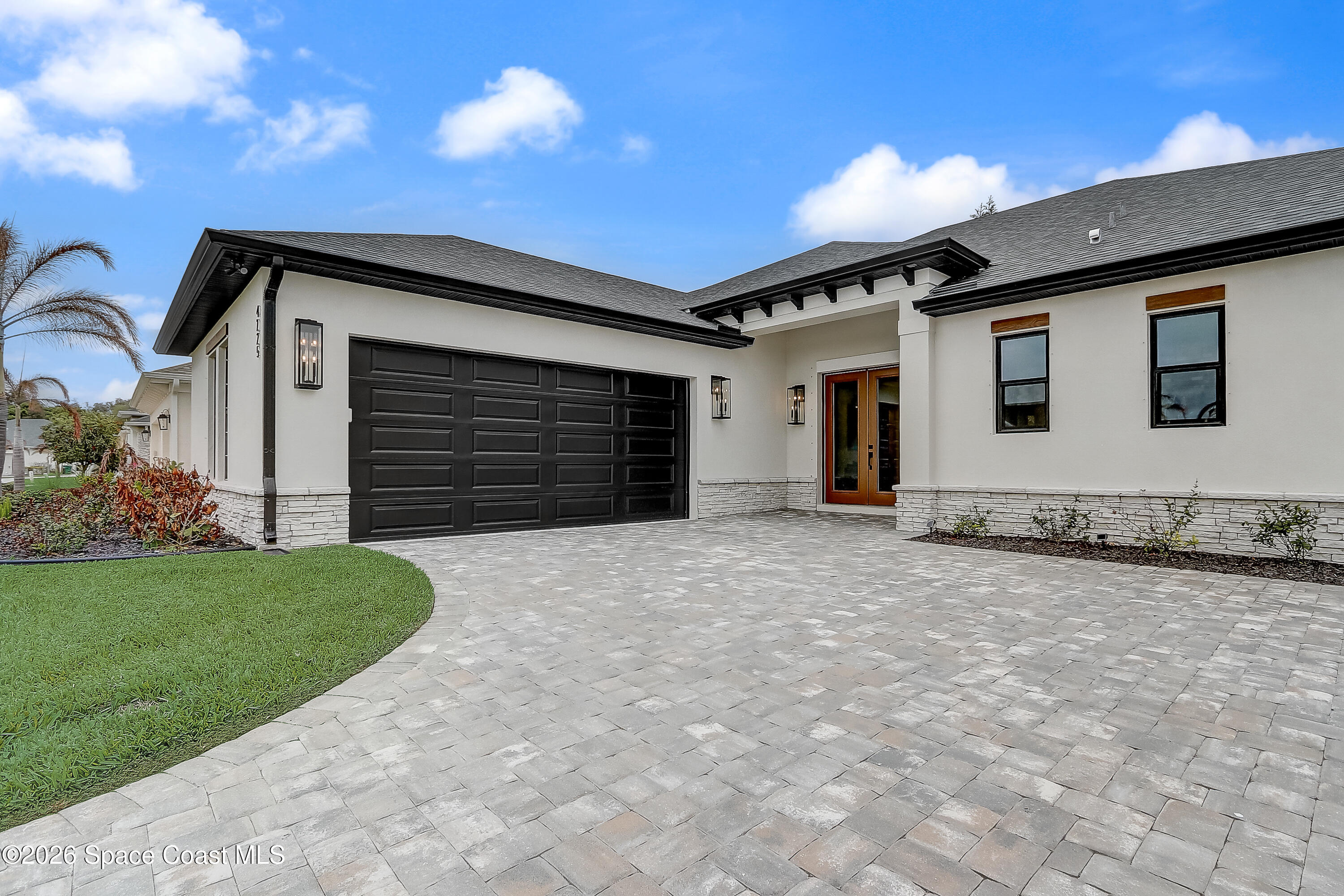 4225 Negal Circle Melbourne, FL 32901 - Photo 6 of 62 a front view of a house with a yard and garage