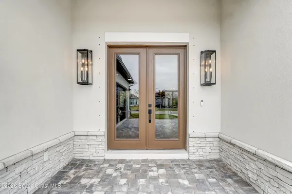 a view of a livingroom with furniture and floor to ceiling window