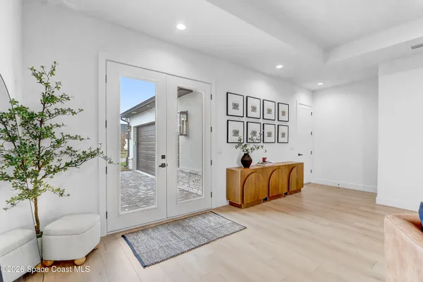 a view of a chair and table in backyard of the house