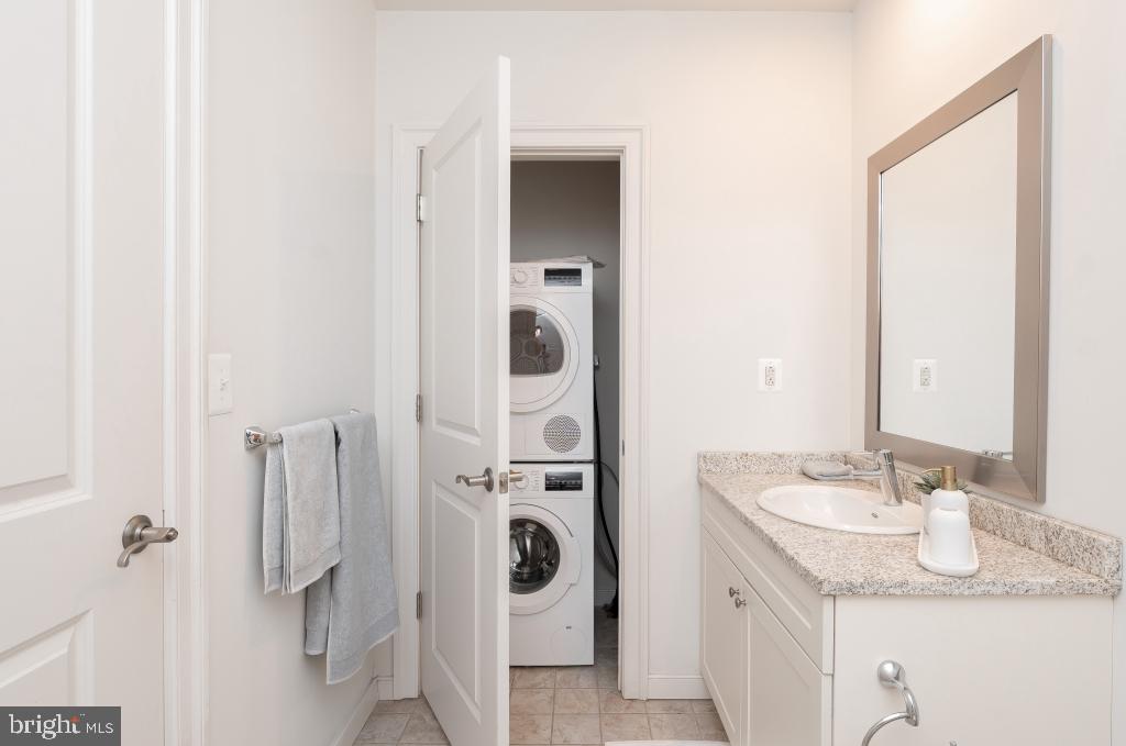 1900-20 Arch Street, Unit 1017 Philadelphia, PA 19103 - Photo 12 of 30 a en suite bathroom with a granite countertop sink and a mirror