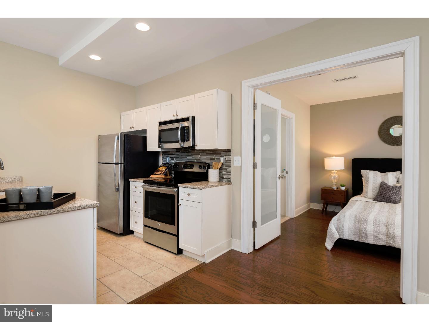 1900-20 Arch Street, Unit 1017 Philadelphia, PA 19103 - Photo 5 of 30 a bedroom with a bed and a television