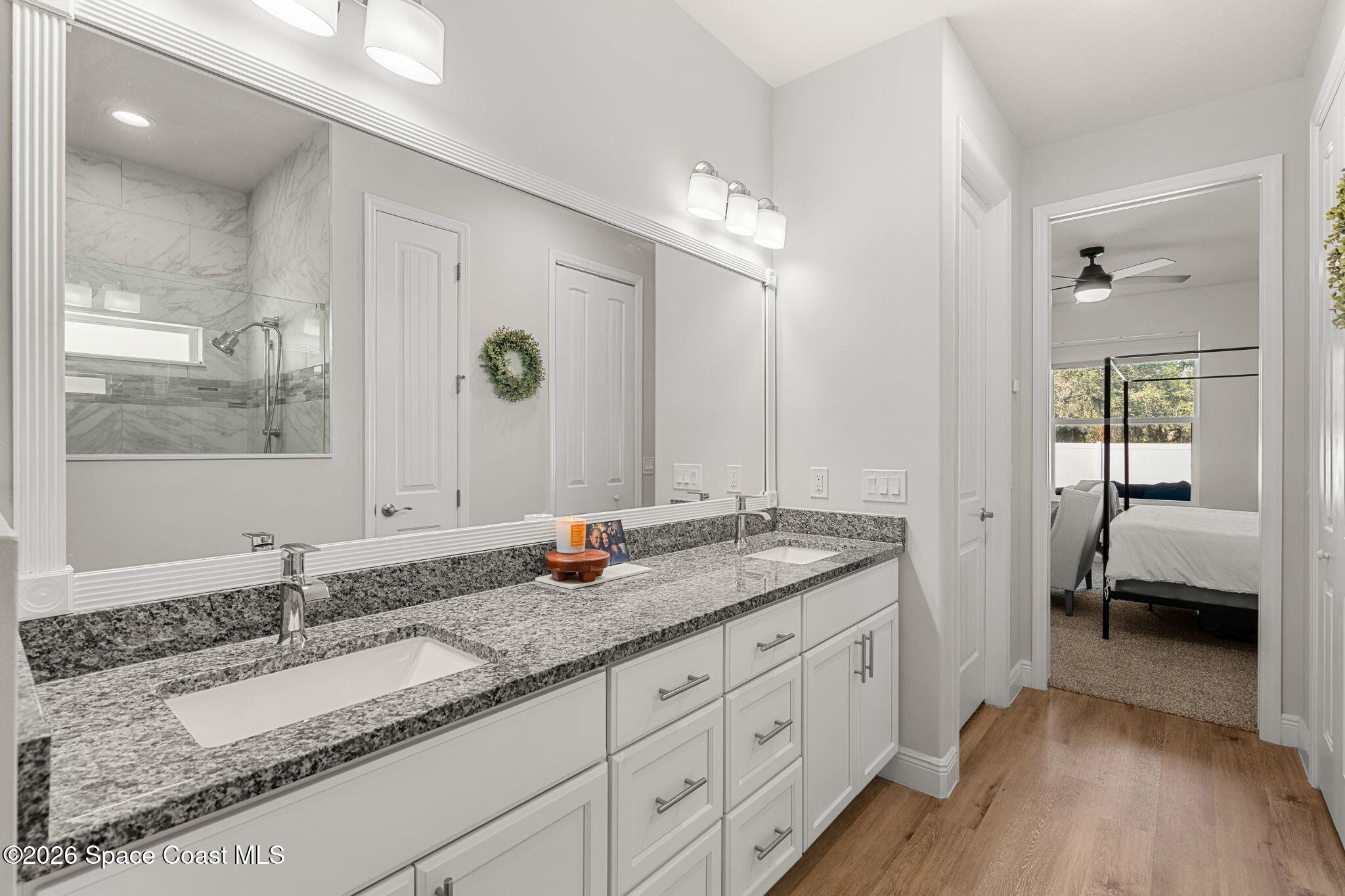 840 Hawks Ridge Court Northeast Palm Bay, FL 32905 - Photo 16 of 41 a en suite bathroom with double sink and a mirror