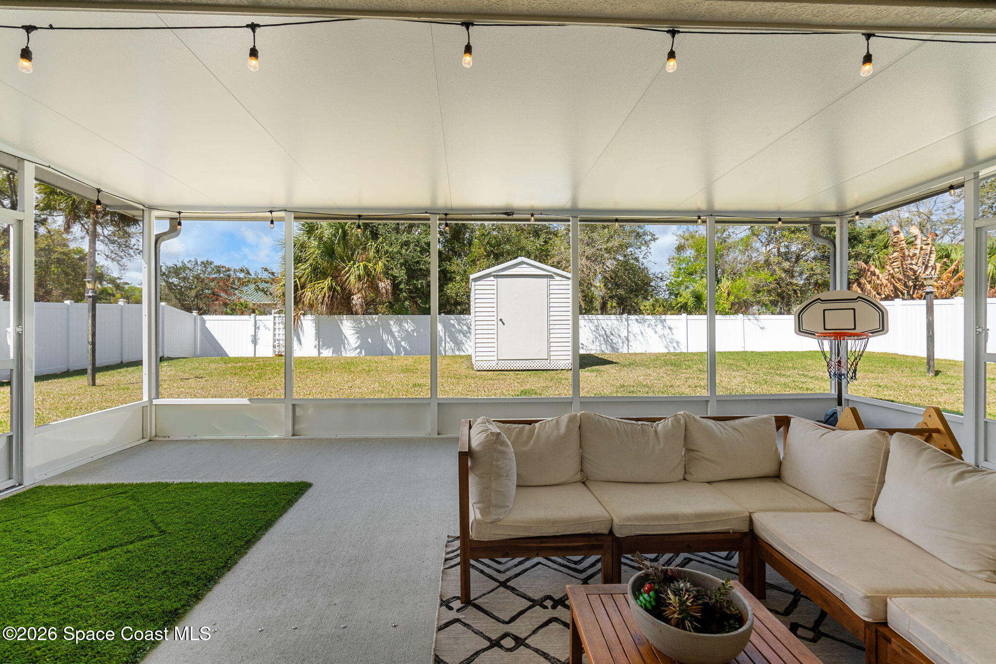 840 Hawks Ridge Court Northeast Palm Bay, FL 32905 - Photo 26 of 41 a living room with furniture and a floor to ceiling window