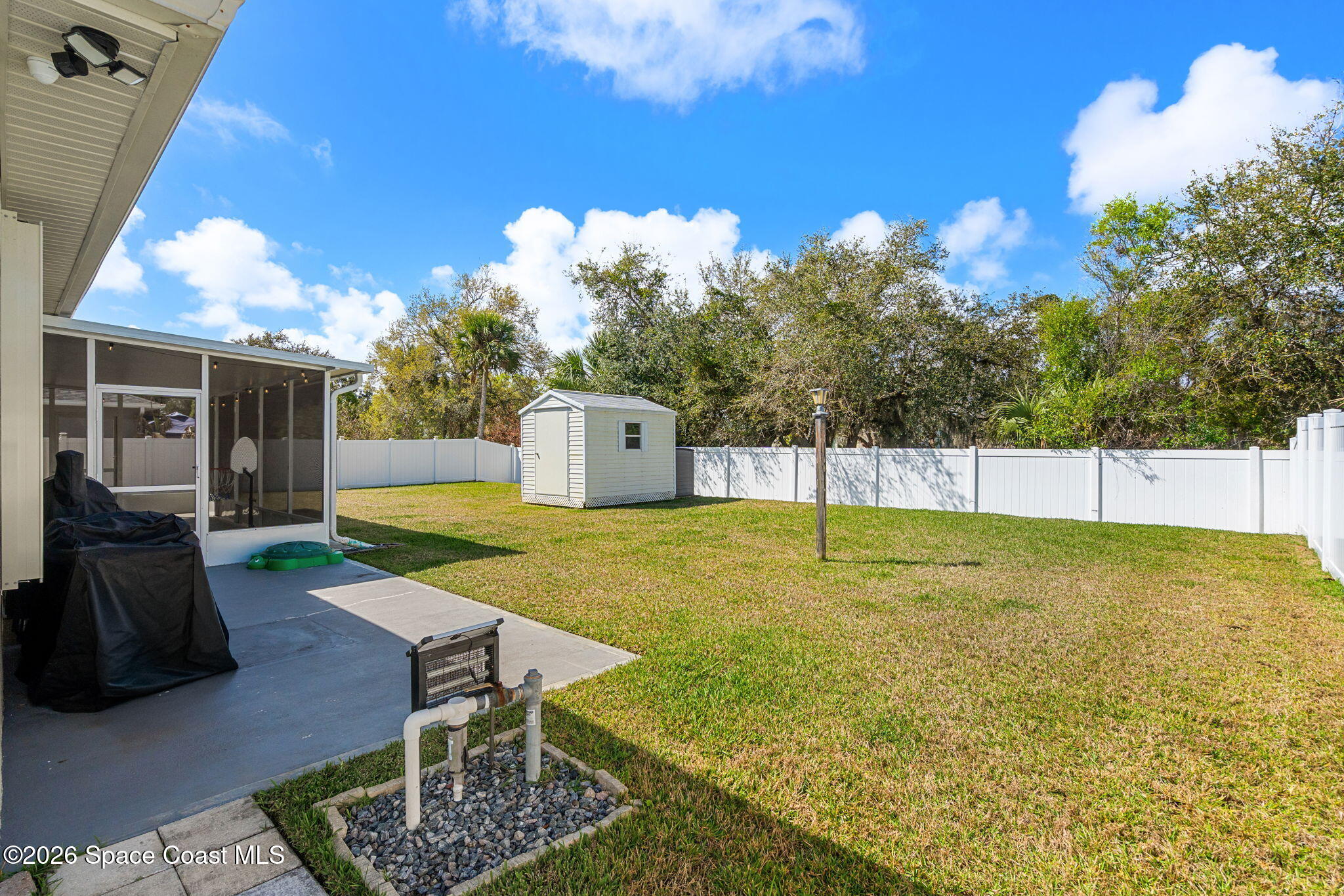840 Hawks Ridge Court Northeast Palm Bay, FL 32905 - Photo 30 of 41 a swimming pool with some trees in the background
