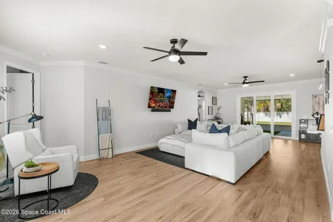 a living room with furniture and a wooden floor