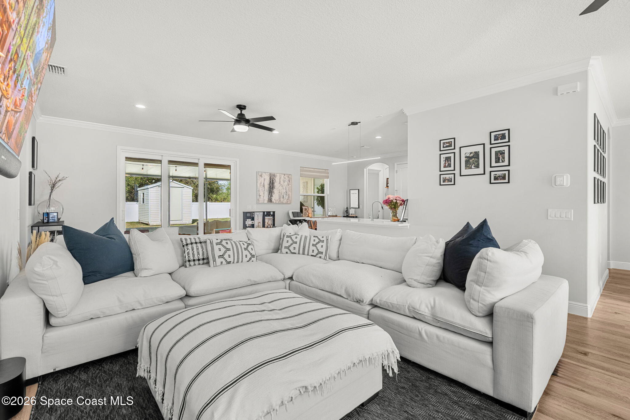840 Hawks Ridge Court Northeast Palm Bay, FL 32905 - Photo 5 of 41 a living room with couches and a view of kitchen