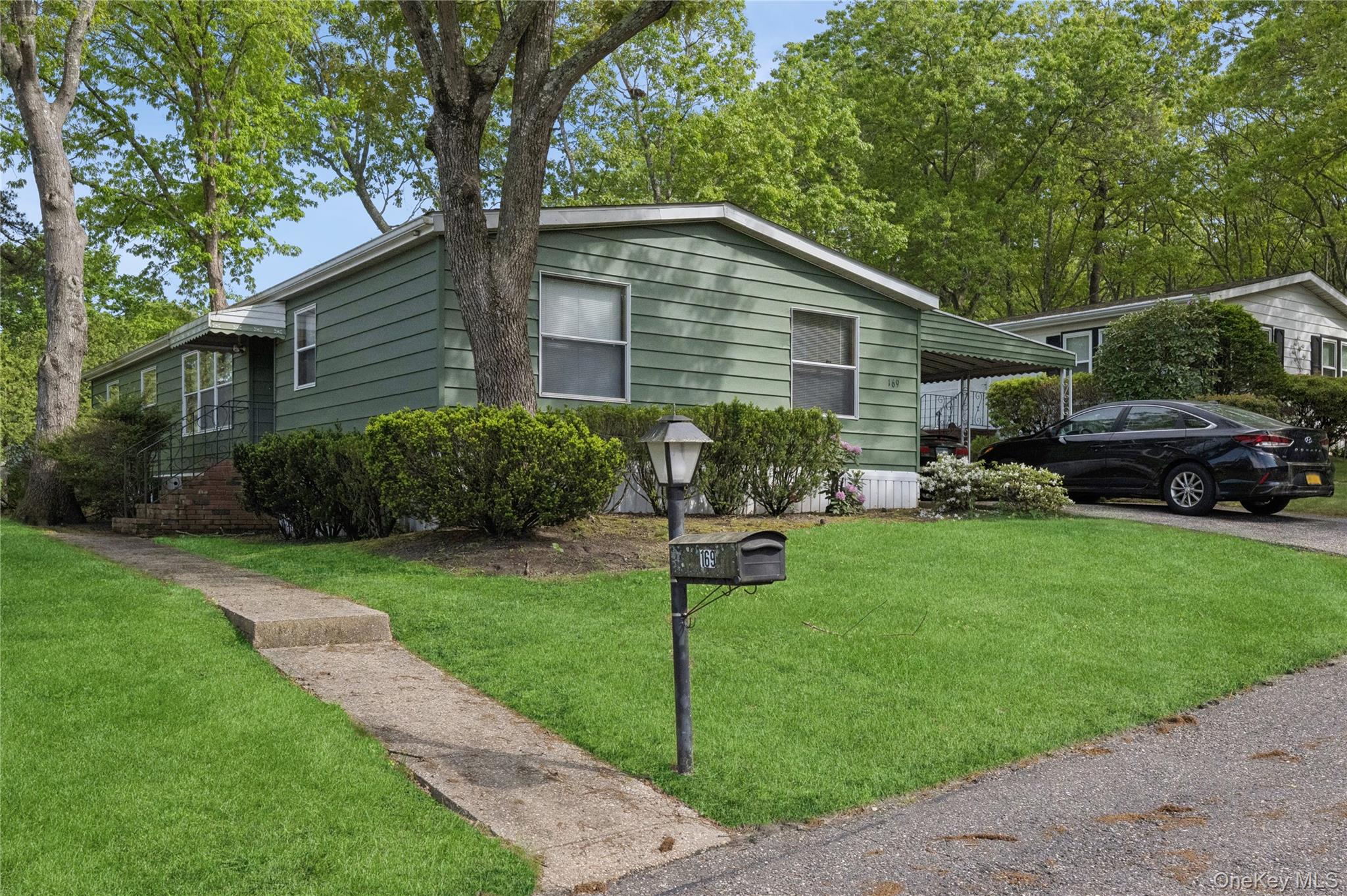 a backyard of a house with table and chairs