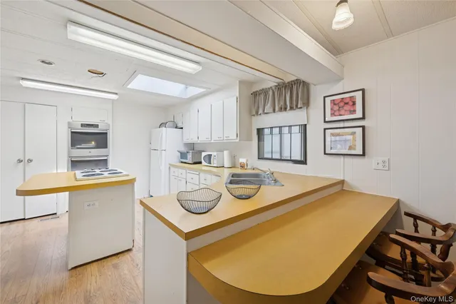a living room with dining table and chairs