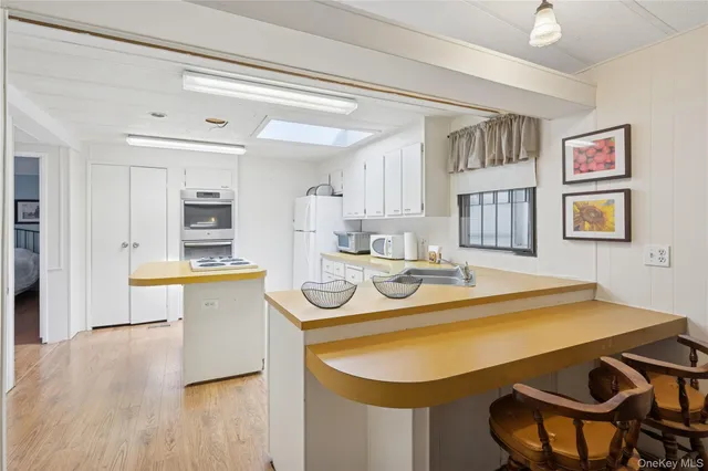 a kitchen with a sink cabinets and wooden floor