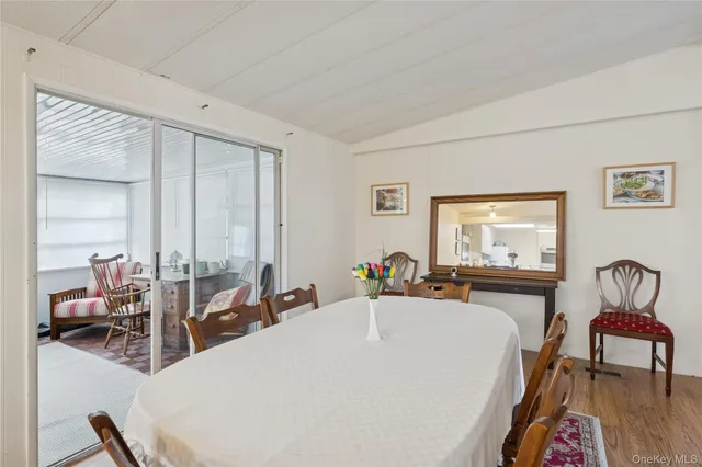 a living room with furniture a flat screen tv and a large window