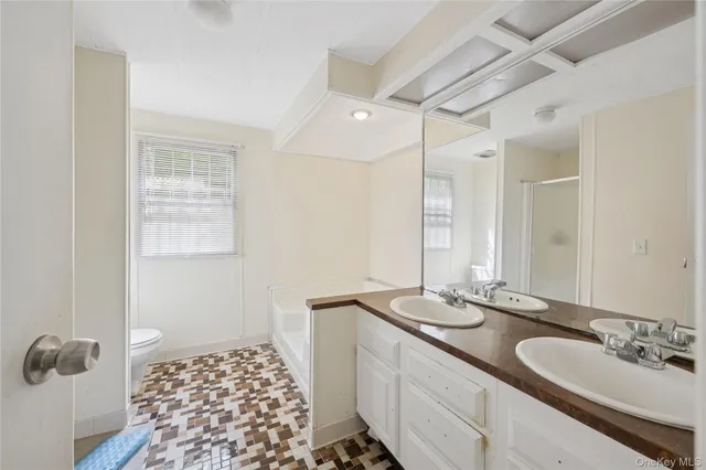 a bathroom with a double vanity sink and a mirror