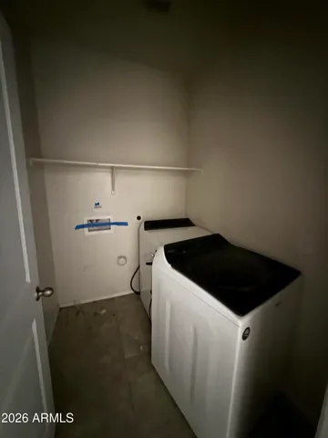 a view of a kitchen with a sink and a refrigerator