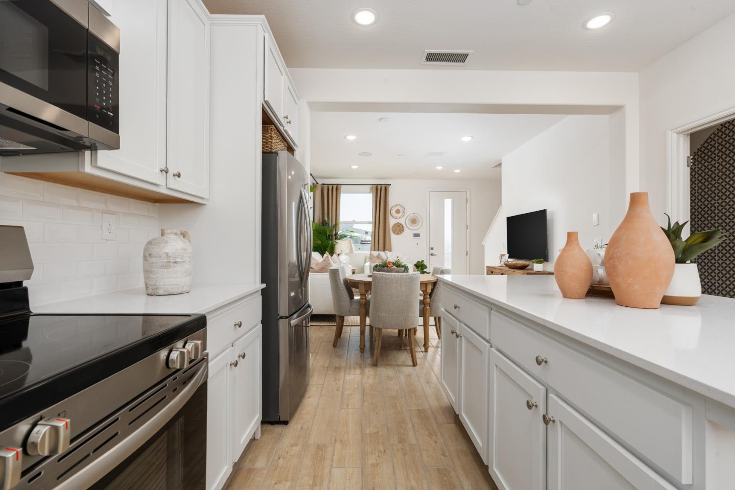 1532 Redbrick Lane Clovis, CA 93619 - Photo 12 of 33 a kitchen with lots of counter space and stainless steel appliances