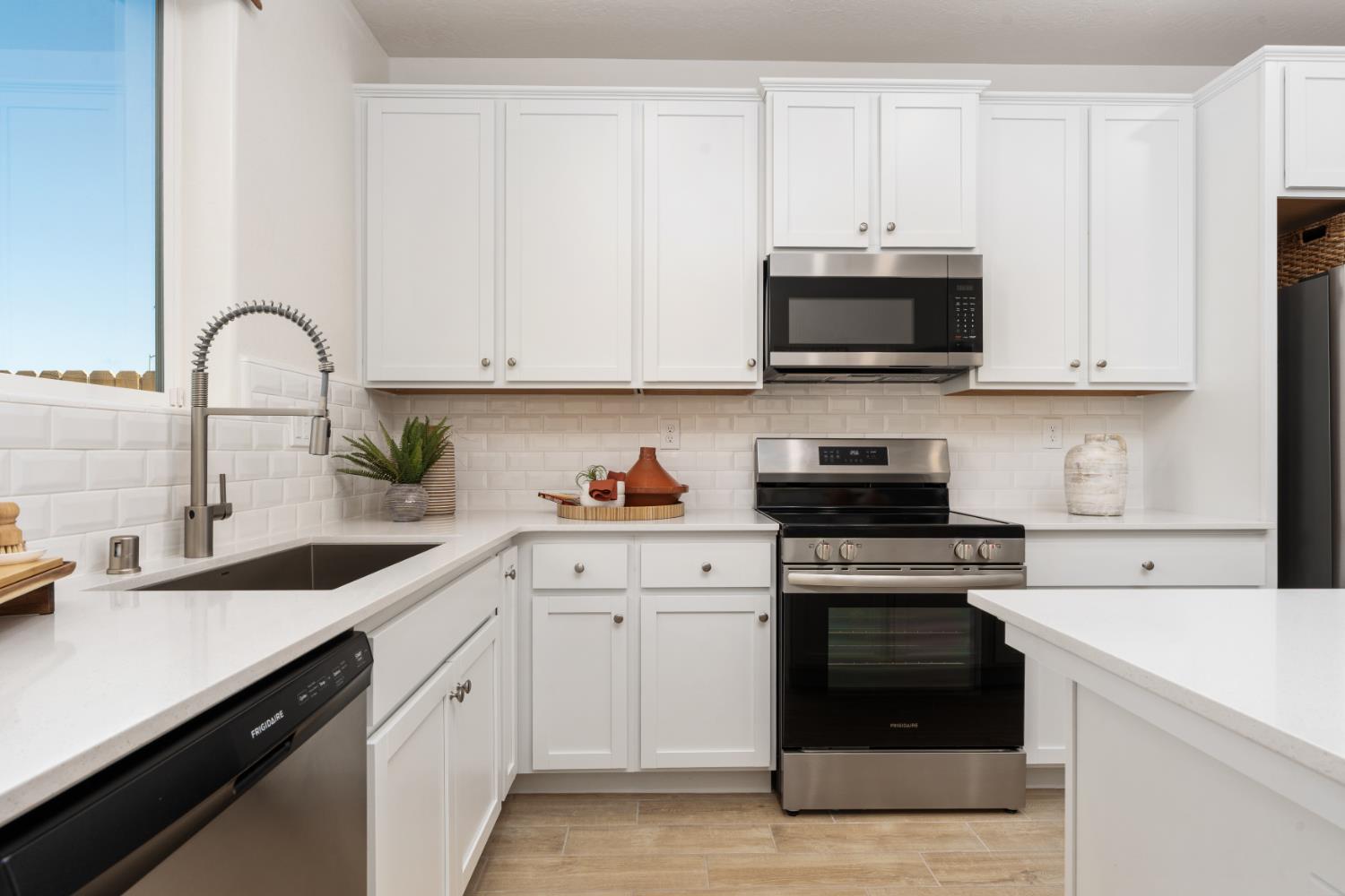 1532 Redbrick Lane Clovis, CA 93619 - Photo 10 of 33 a kitchen with stainless steel appliances granite countertop a sink a stove and a microwave