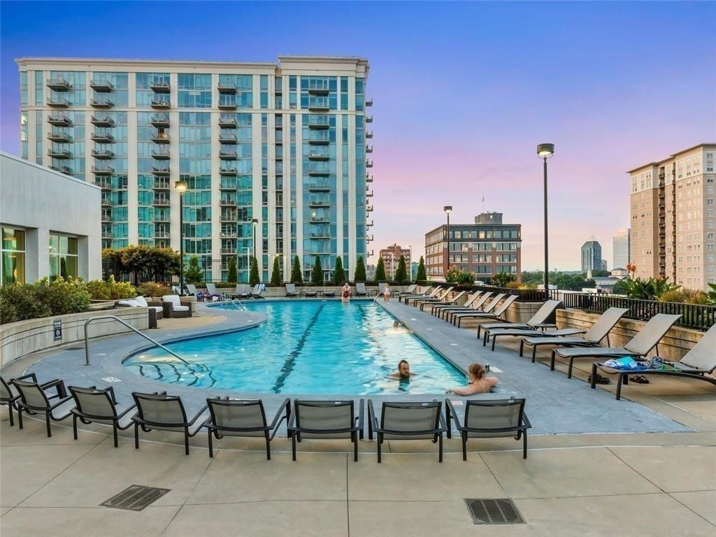 250 Pharr Road Northeast, Unit 601 Atlanta, GA 30305 - Photo 23 of 34 a view of a swimming pool with outdoor seating