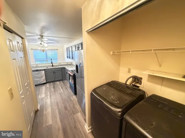 a kitchen that has a lot of cabinets and wooden floor
