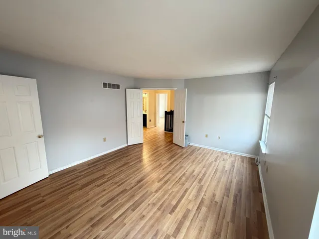 a view of a room with wooden floor and window