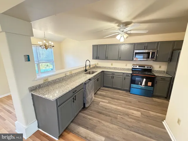 a kitchen with stainless steel appliances granite countertop a sink and dishwasher