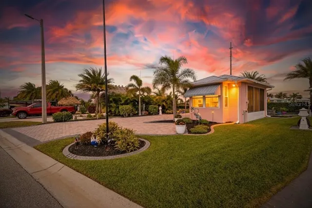a view of a house with swimming pool and sitting area