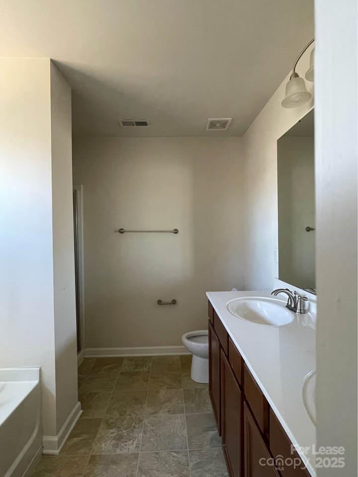 8715 Balsam Bay Road Charlotte, NC 28227 - Photo 13 of 15 a bathroom with a sink toilet and tub