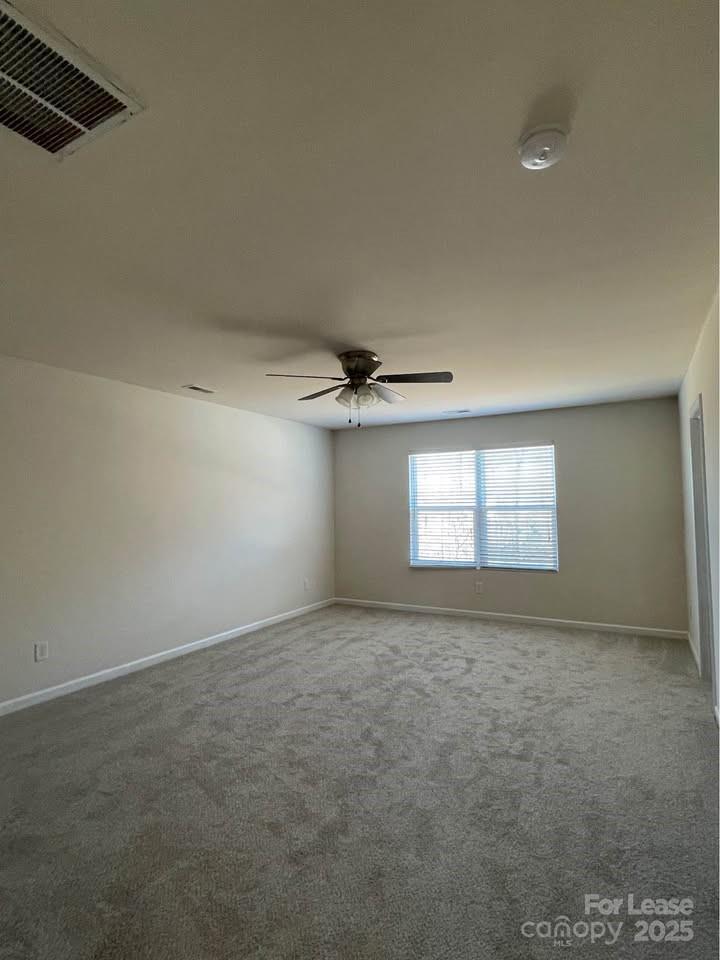 8715 Balsam Bay Road Charlotte, NC 28227 - Photo 14 of 15 an empty room with windows and ceiling fan