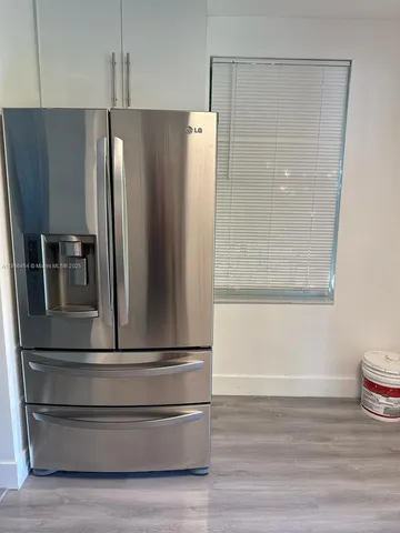 a refrigerator freezer sitting in a kitchen