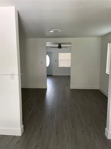 a view of a room with wooden floor and window