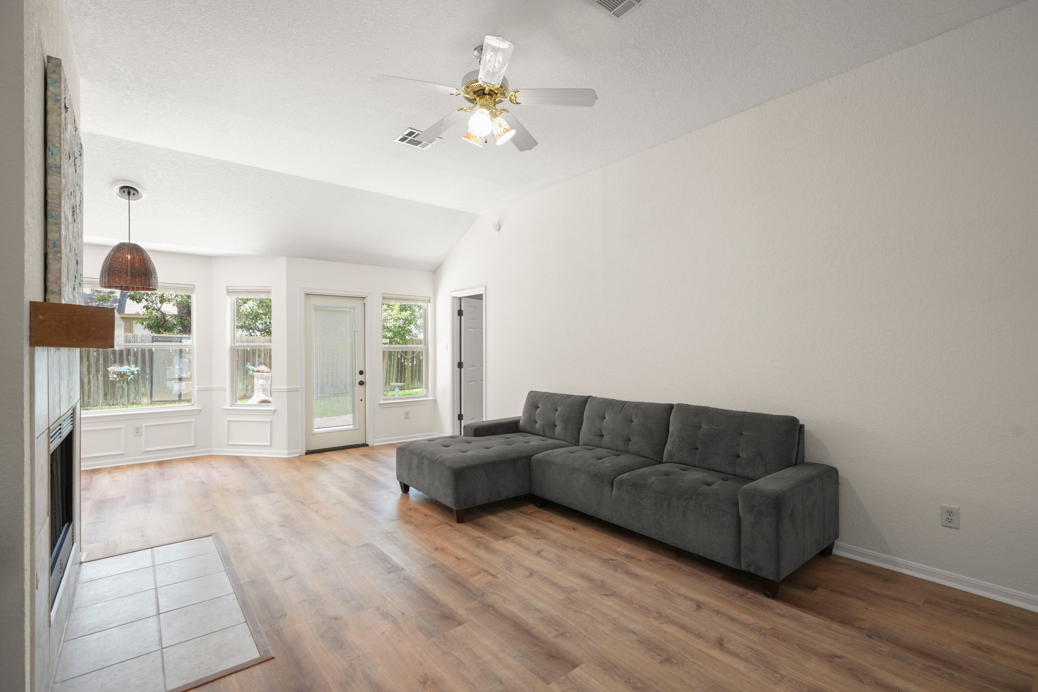 438 Katy Crossing Georgetown, TX 78626 - Photo 3 of 24 A spacious living room featuring wood flooring and a charming fireplace.
