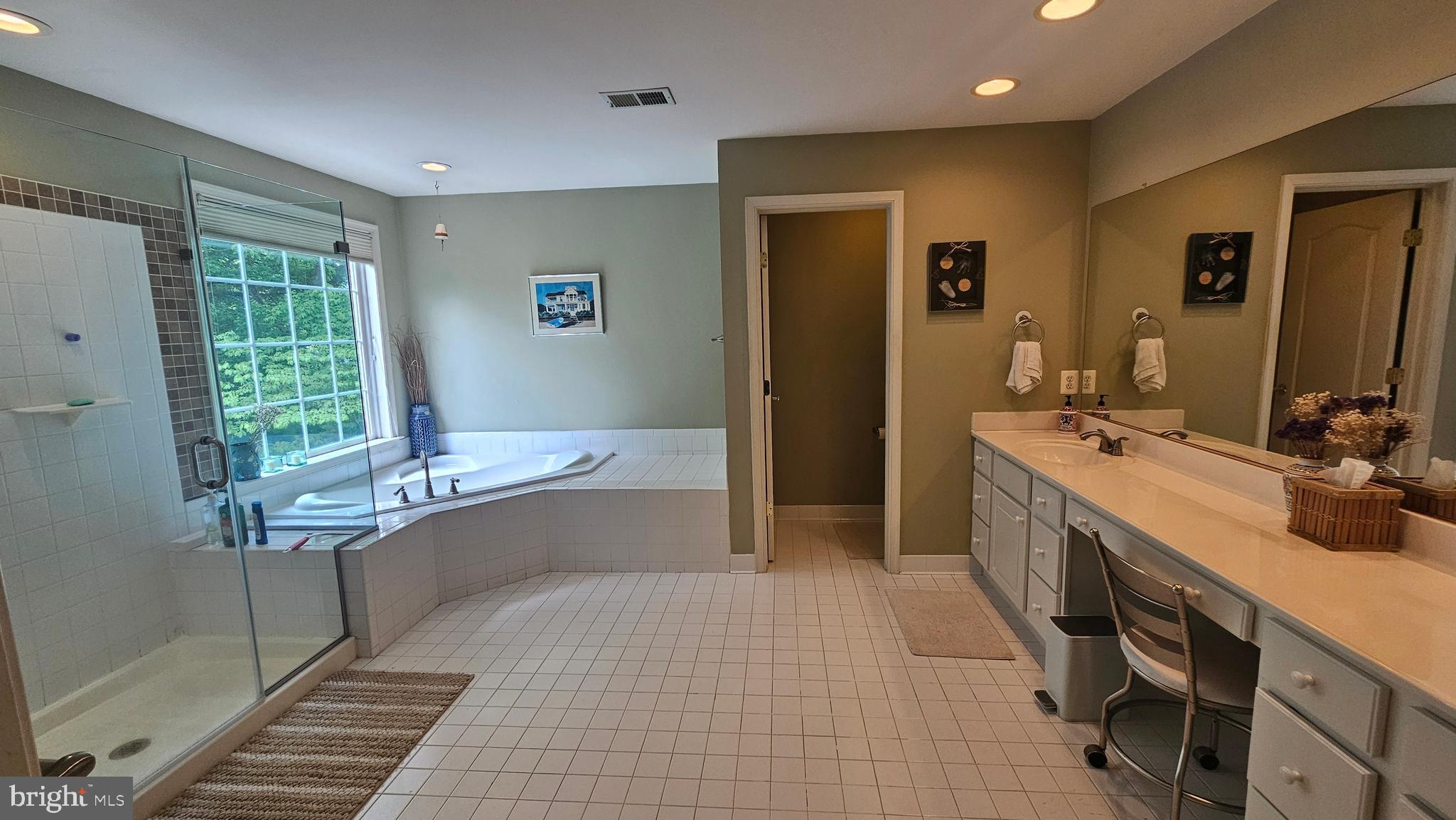 6107 Traceys Overlook Road Tracys Landing, MD 20779 - Photo 27 of 67 a bathroom with a tub sink and mirror