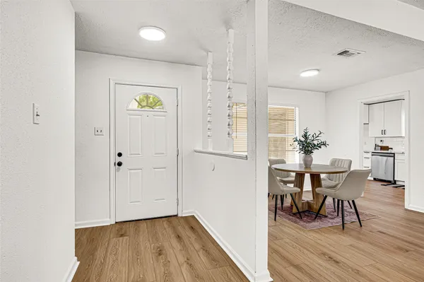 an empty room with a window and a ceiling fan