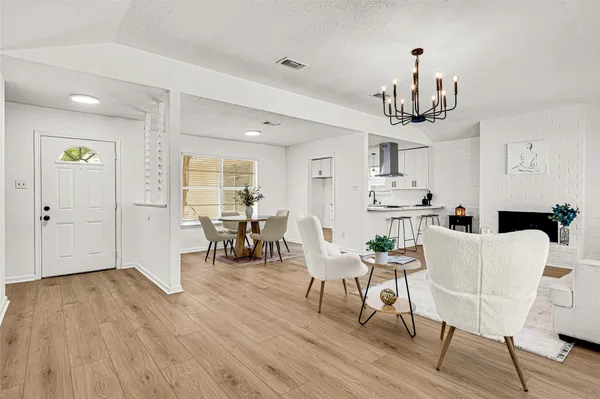 a living room with furniture a fireplace and a table