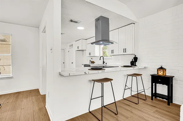 a kitchen with a sink a stove and cabinets