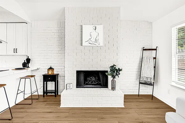 a kitchen with stainless steel appliances white cabinets and a wooden floor