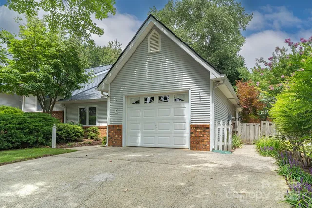 a view of a house with a yard and garage