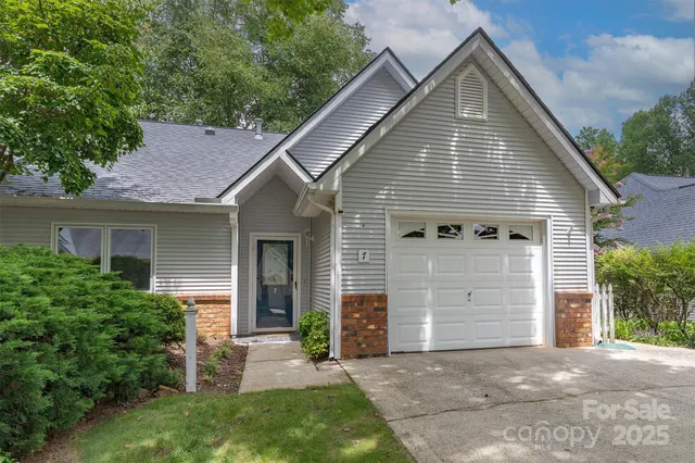 a view of a house with a yard and garage