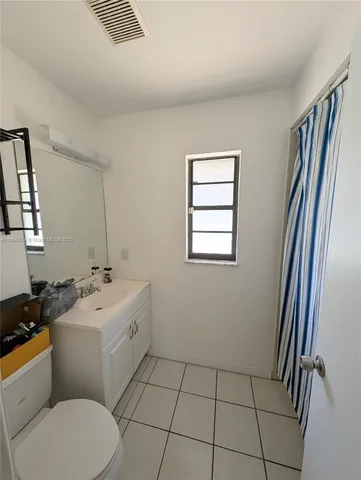 a bathroom with a sink toilet and mirror