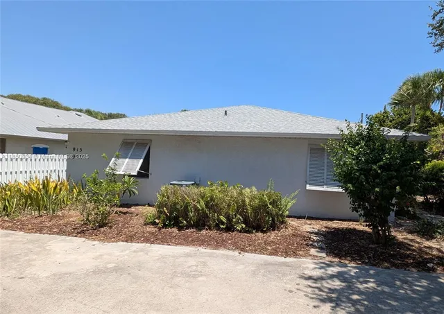 a front view of a house with a yard and a garage