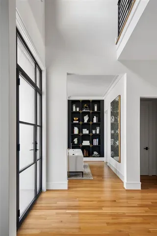 a view of empty room with wooden floor and window