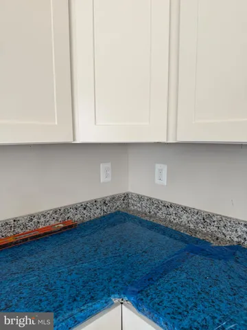 an empty room with wooden floor and cabinets