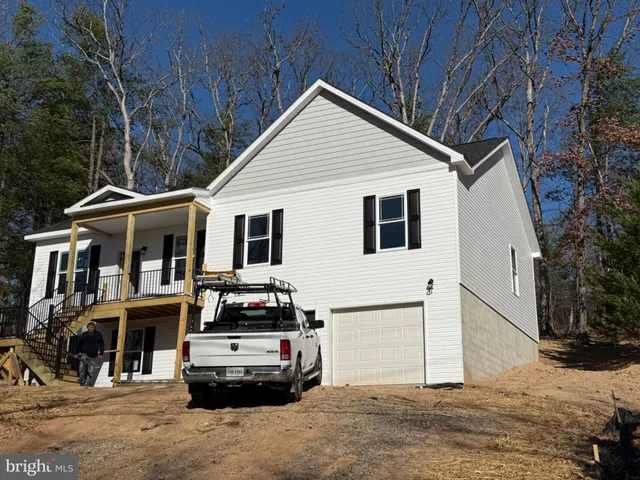 a car parked in front of white house