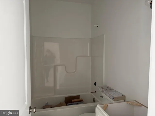 a bathroom with a granite countertop sink mirror and toilet
