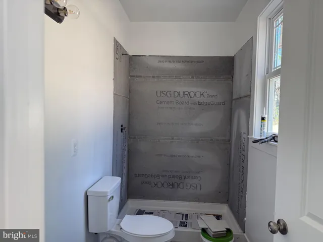 a bathroom with a toilet and a shower