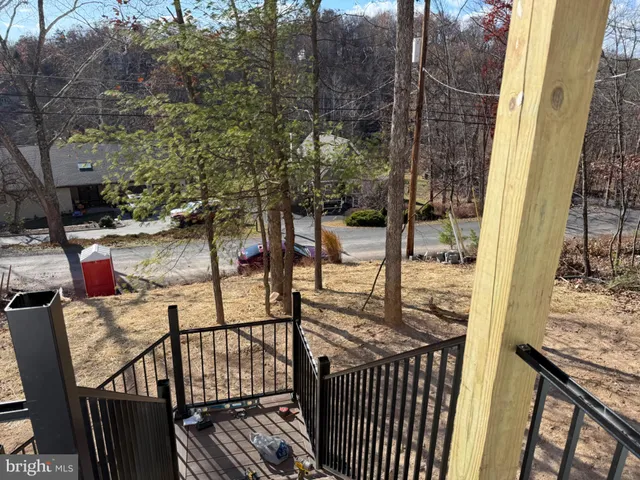 a view of balcony with wooden floor and seating space