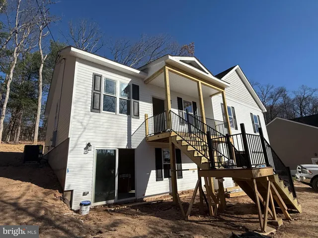 a front view of a house with mountain