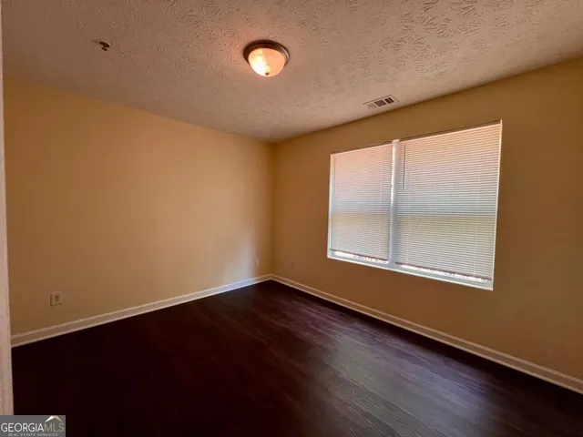 a bathroom with a granite countertop sink toilet a mirror and shower