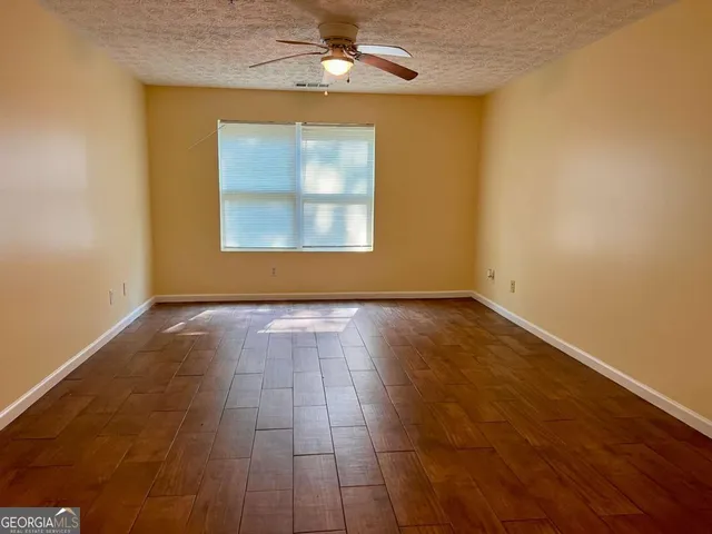 a kitchen with granite countertop stainless steel appliances a sink stove and refrigerator