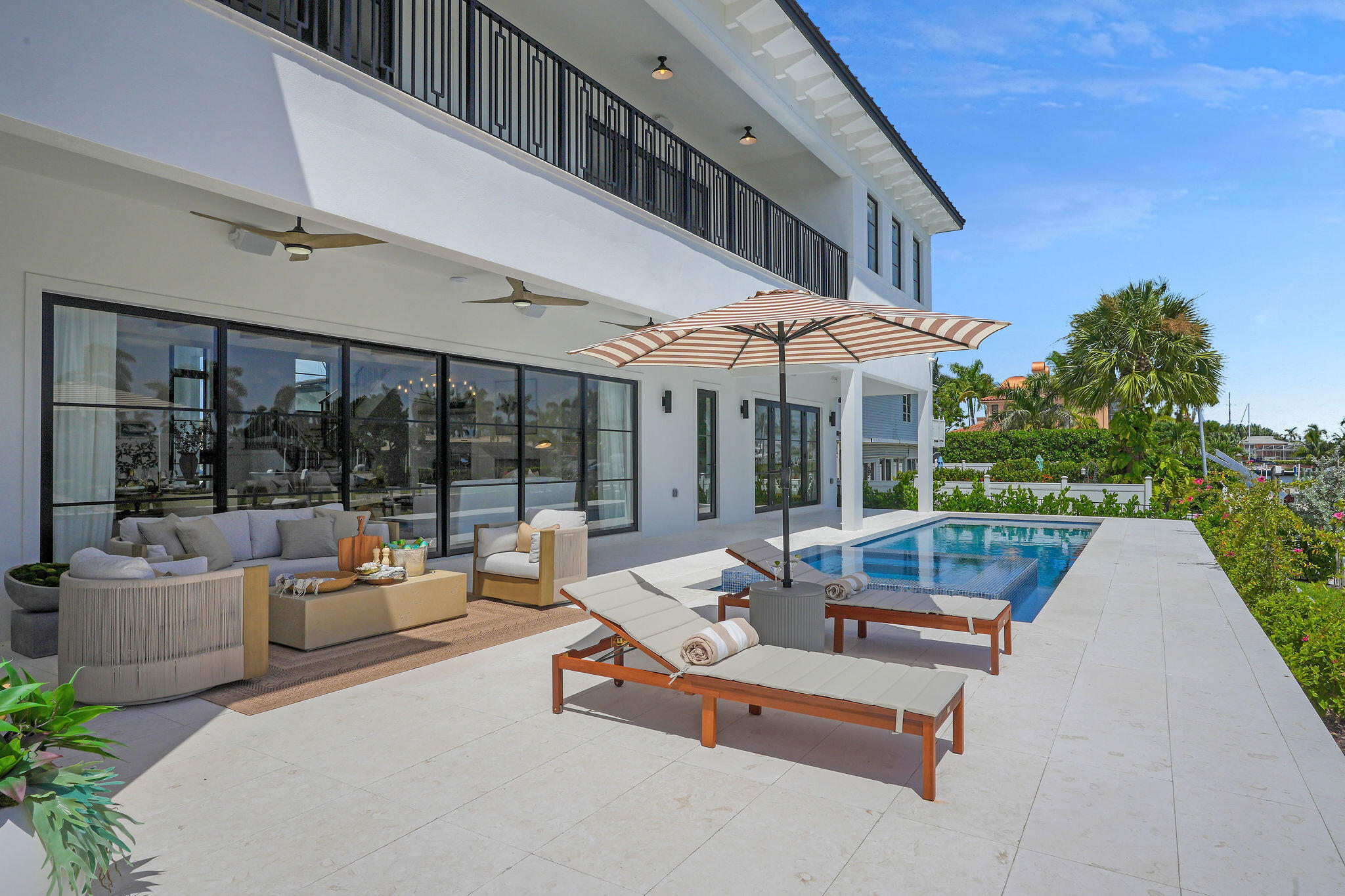 839 Chestnut Court Marco Island, FL 34145 - Photo 63 of 88 Pool with lounge chairs & umbrella