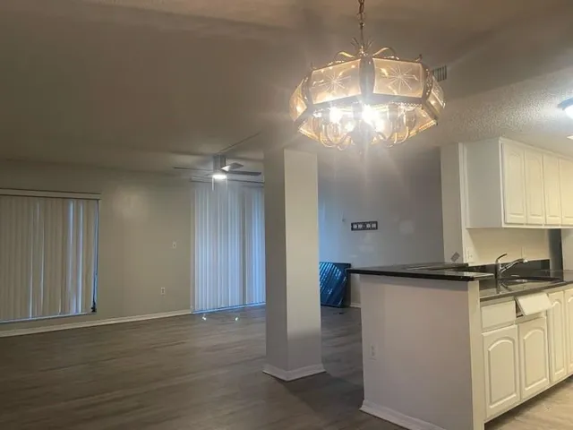 a view of a kitchen with an empty space and a window
