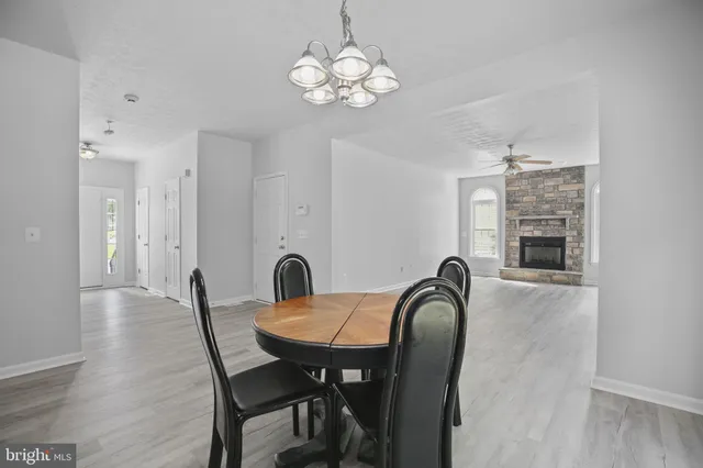 a view of a dining room with furniture and chandelier