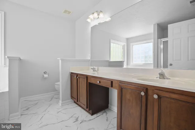 a sink with a granite countertop cabinets